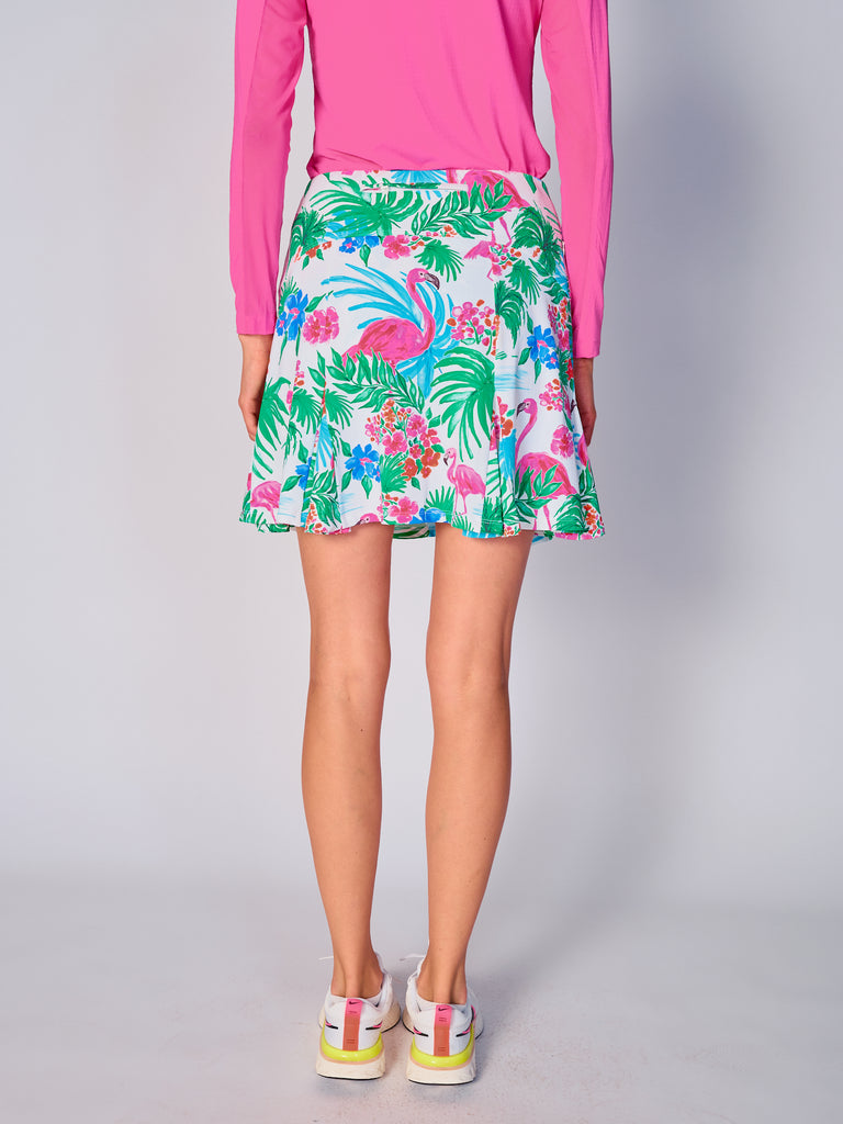 The close-up image showcases the back view of the G Lifestyle Flare Godet Skort in Flamingo - tropical print of the Spring Summer 2024 Collection. The skort waistband is flat and wide with a single horizontal utility pocket with zip closure. The subtle texture of the soft stretchy fabric is noticeable. The stitching is meticulous, ensuring a durable and comfortable fit. This skort is suitable for tennis, pickleball, padel tennis, golf. 