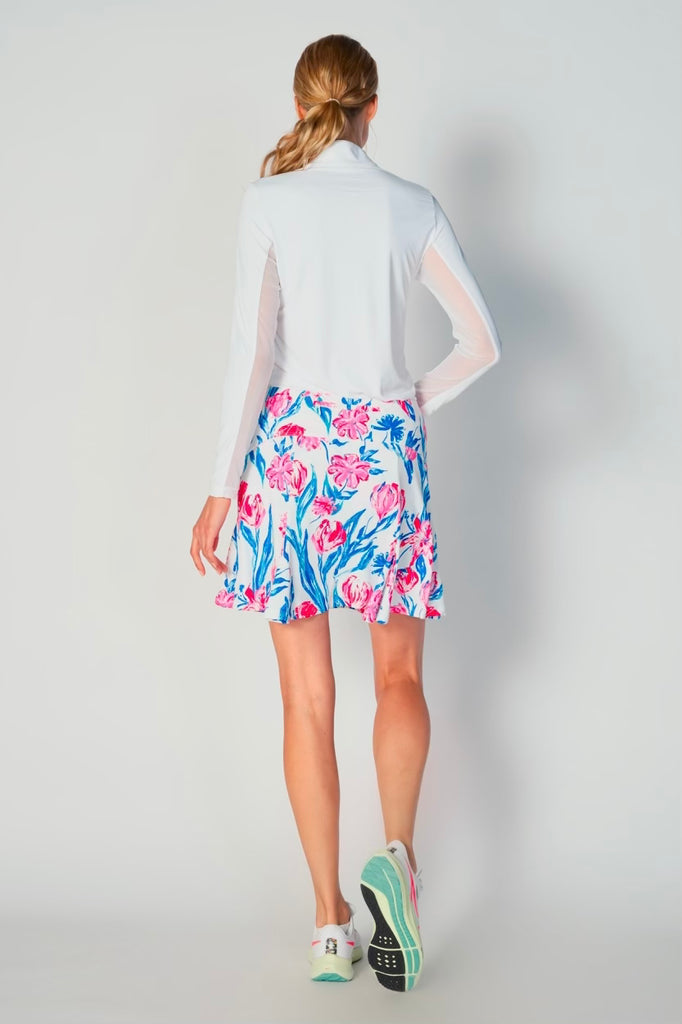 The image showcases the back view of the G Lifestyle Flare Godet Skort in Tulip - floral print of the Spring Summer 2024 Collection. The subtle texture of the soft stretchy fabric is noticeable. The stitching is meticulous, ensuring a durable and comfortable fit. This skort is suitable for tennis, pickleball, padel tennis, golf. 