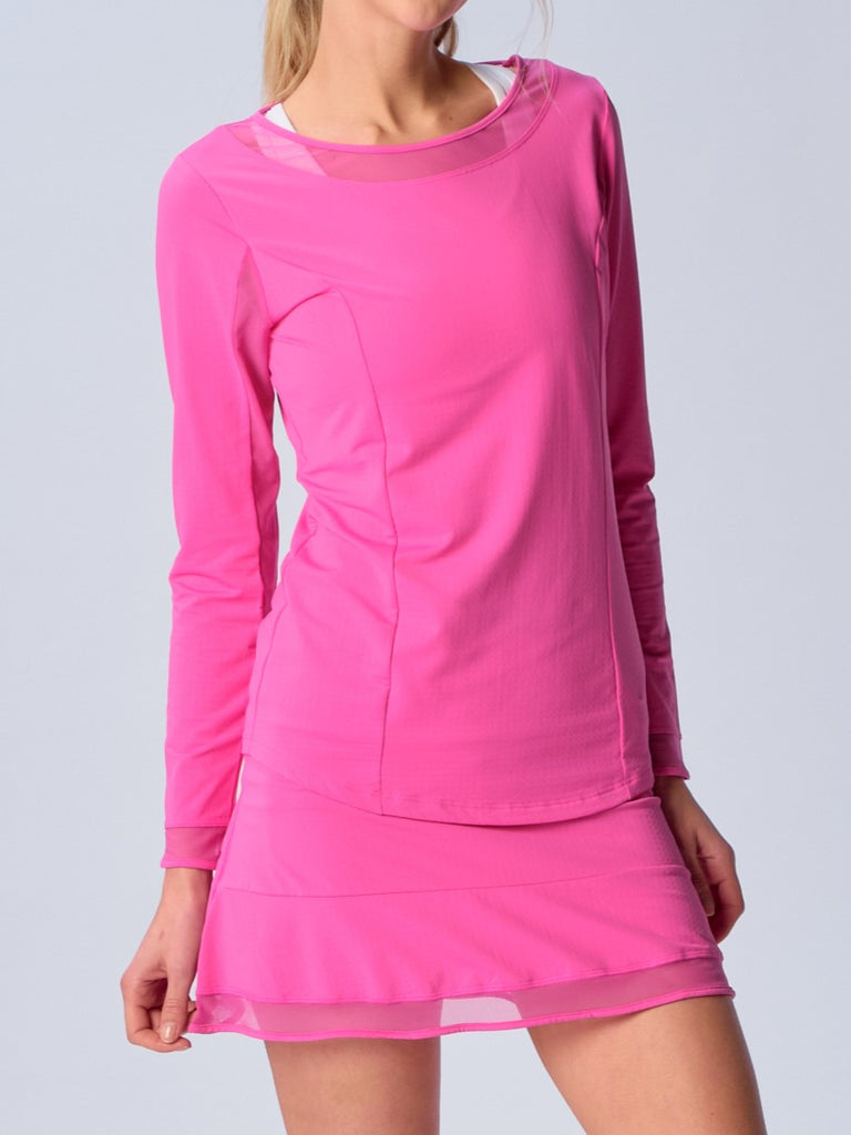 A woman wears G Lifestyle Mesh Block Long Sleeve Top in Hot Pink. The top is designed with long sleeves, mesh underarm inserts for breathability, and features a round neckline with texture mesh block detailing around it and sleeve hems. The fabric appears to be lightweight, movement-friendly, with subtle texture. Suitable for various outdoor athletic activities such as golf, tennis, padel tennis, pickleball or even cycling.