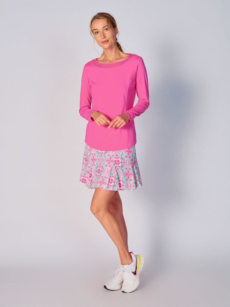 A woman wears G Lifestyle Mesh Block Long Sleeve Top in Hot Pink. The top is designed with long sleeves, mesh underarm inserts for breathability, and features a round neckline with texture mesh block detailing around it and sleeve hems. The fabric appears to be lightweight, movement-friendly, with subtle texture. Suitable for various outdoor athletic activities such as golf, tennis, padel tennis, pickleball or even cycling.