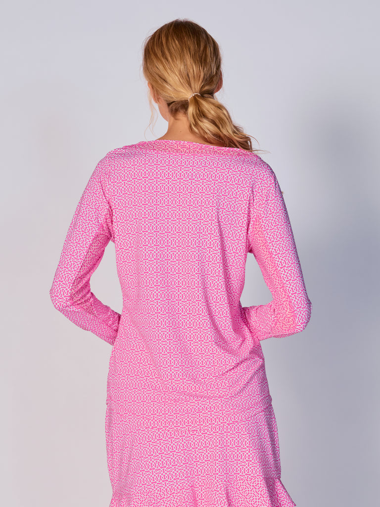 A woman is showcasing the back of the G Lifestyle Mesh Block Long Sleeve Top in Cubic Hot Pink - geometric print of the Spring Summer 2024 Collection. The top is tailored with a snug fit silhouette, complete with long sleeves and round neckline with mesh details. Notably, it includes smooth mesh underarm inserts, which are seamlessly integrated for enhanced breathability, ensuring comfort during active use. 